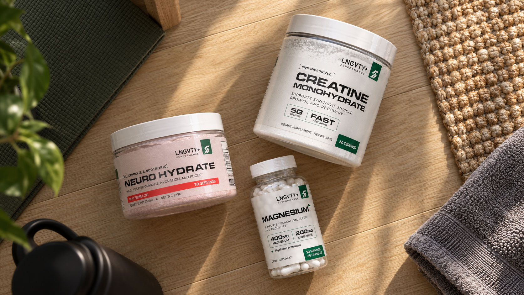 Flat lay of Neuro Hydrate, Creatine Monohydrate, and Magnesium+ beside home workout gear