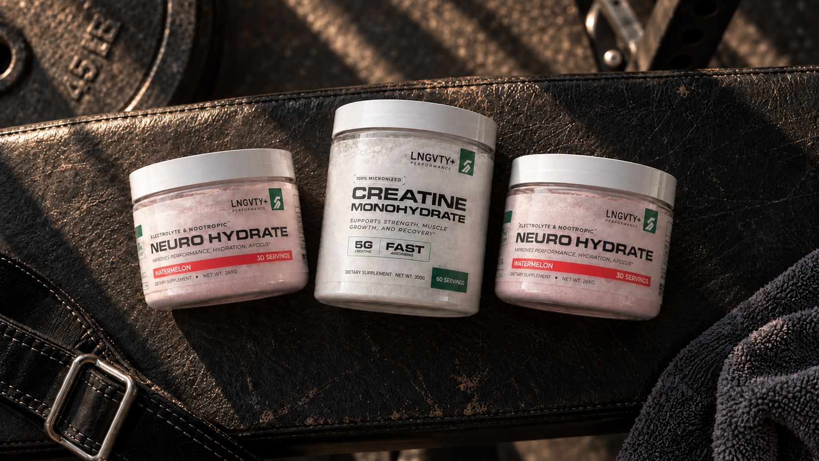 Two Neuro Hydrate tubs and one Creatine Monohydrate tub arranged on a gym bench