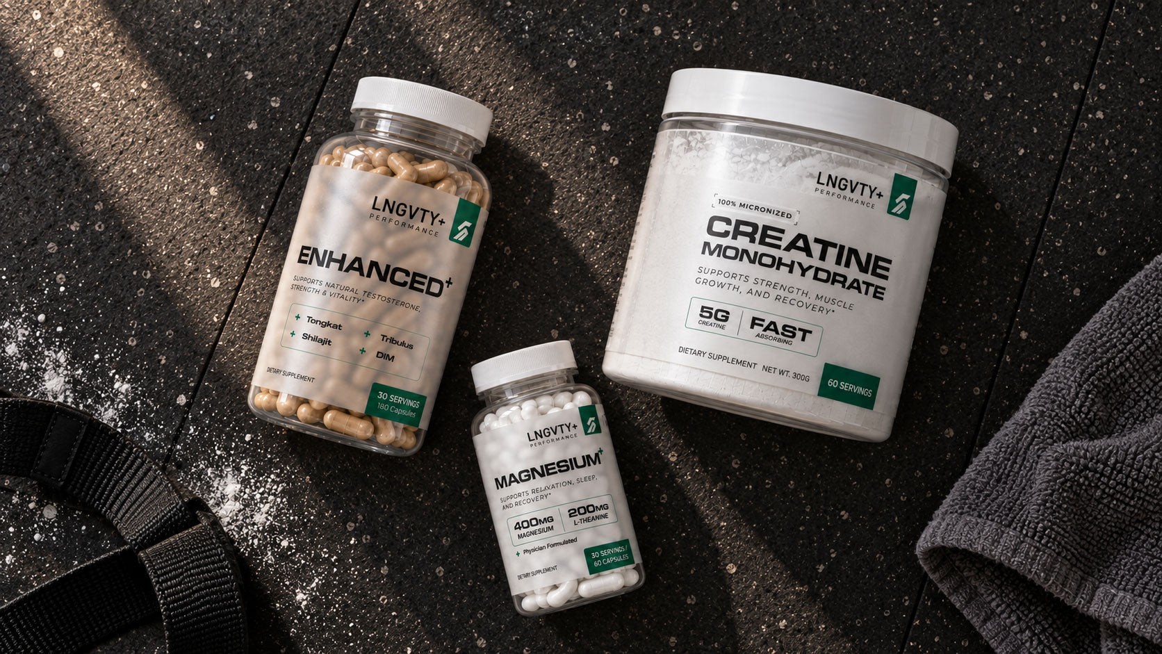 Enhanced+, Magnesium+ and Creatine Monohydrate arranged on a gym floor